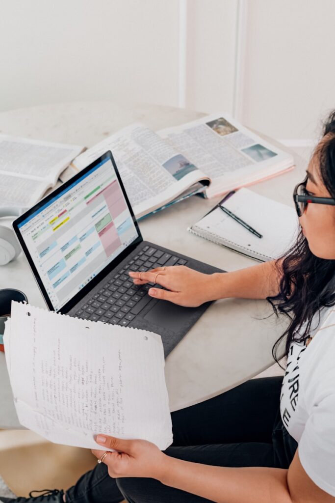 woman in white shirt using Microsoft Surface Laptop 3 in Platinum working on what is a noise impact assessment?