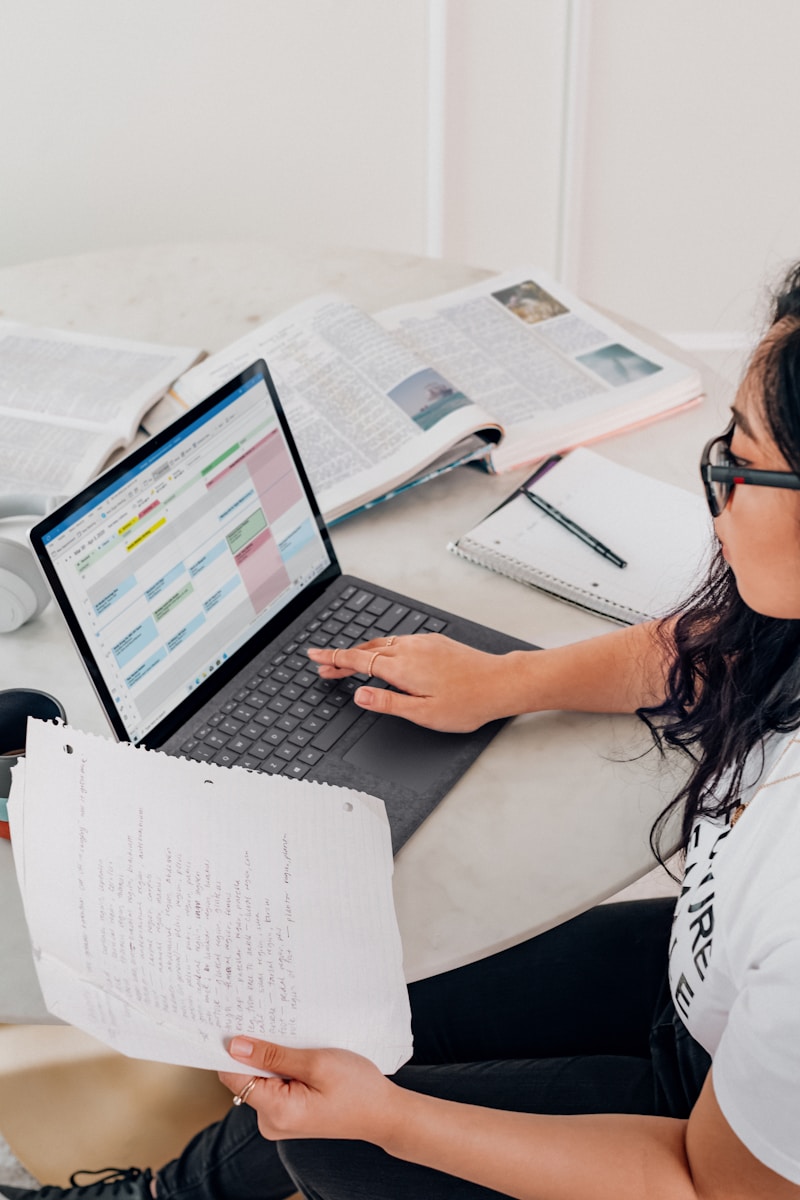 woman in white shirt using Microsoft Surface Laptop 3 in Platinum working on what is a noise impact assessment?