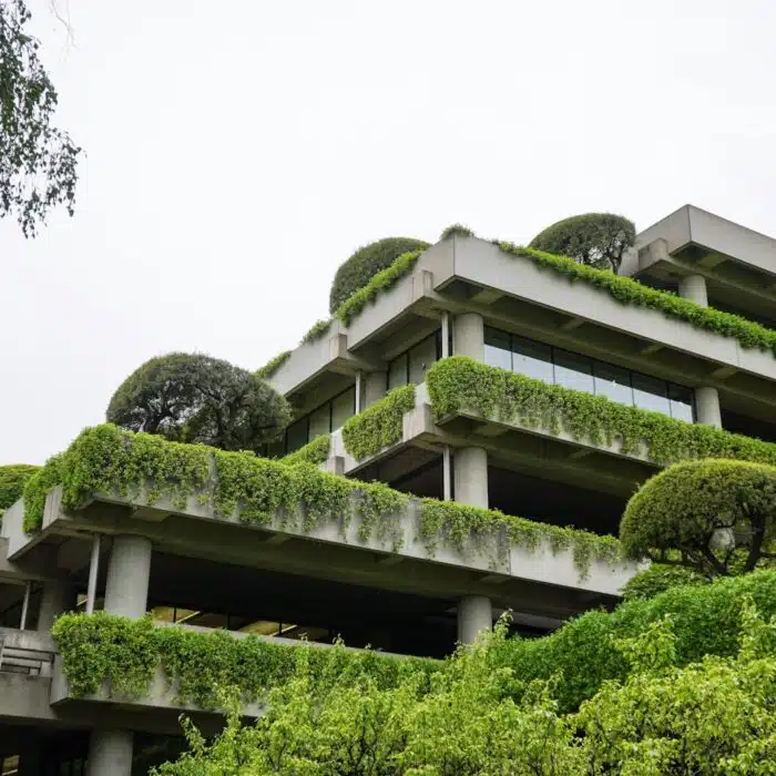 Photo by Joel Durkee a building with a lot of plants growing on it Cross-laminated timber structure being tested for sound insulation Recycled acoustic panels installed in sustainable building interior Diagram comparing embodied carbon of acoustic partition materials Acoustic consultant conducting field sound test beside eco-building