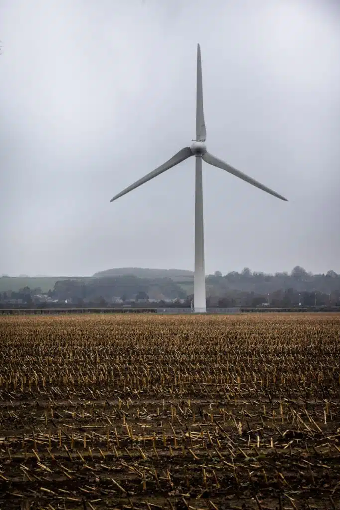 white wind turbine on brown wheat field during daytime assessed by noise survey in the east midlands