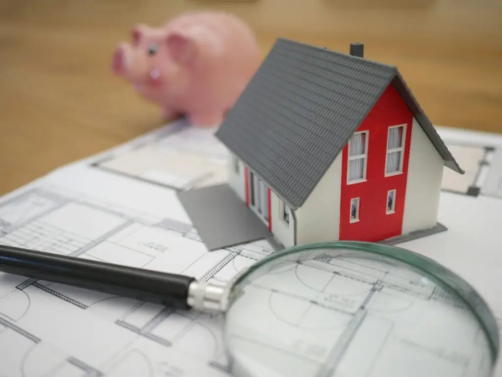 white and red wooden house beside grey framed magnifying glass noise impact assessment cost UK