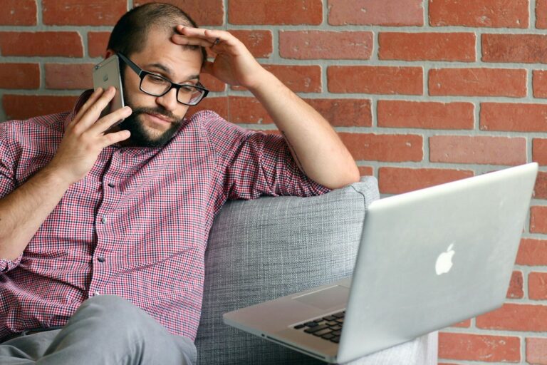 a man with a laptop frustrated by 7 noise issues that are affecting his planning application.